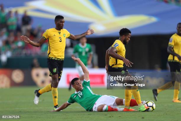 Angel Sepulveda of Mexico fights for the ball with Jermaine Taylor of Jamaica during a match between Mexico and Jamaica as part of CONCACAF Gold Cup...