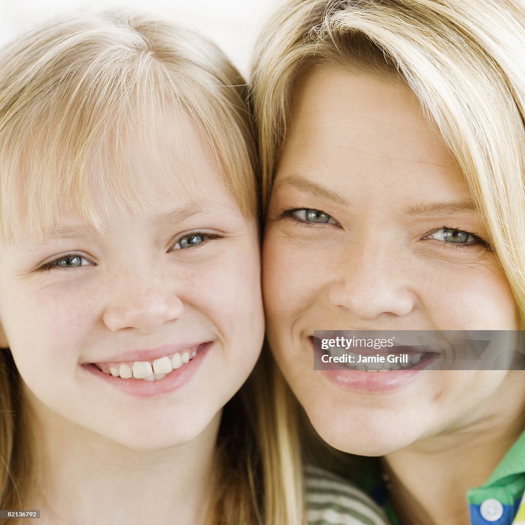 Mother and daughter touching cheeks