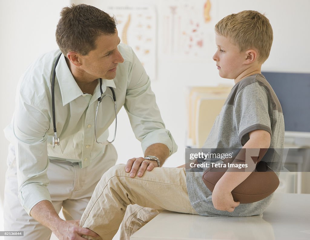 Male doctor examining boy