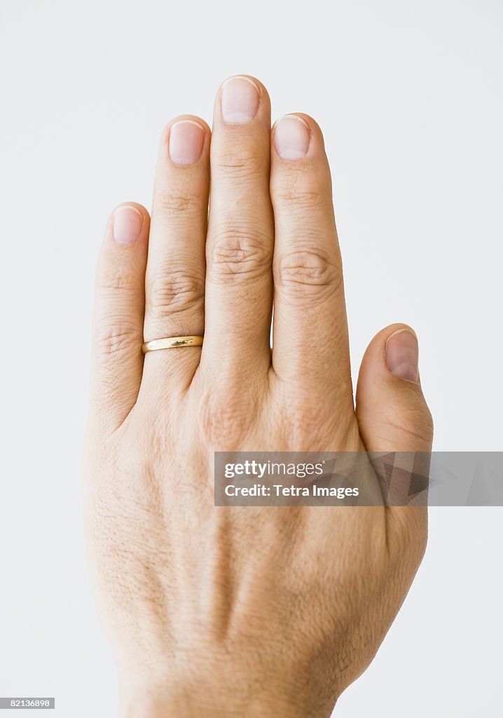 Close up of man?s hand wearing wedding ring