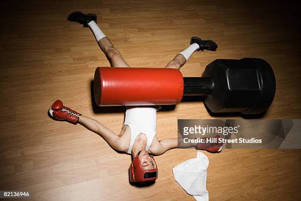 man knocked over by punching bag - defeat stock-fotos und bilder