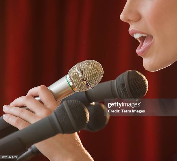 woman speaking into microphone - microphone mouth stock pictures, royalty-free photos & images