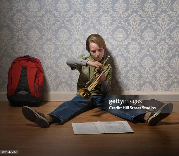 boy holding trumpet - wind instrument stock pictures, royalty-free photos & images