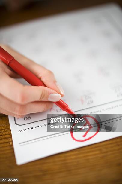 teacher writing f grade on worksheet - letter f stock pictures, royalty-free photos & images