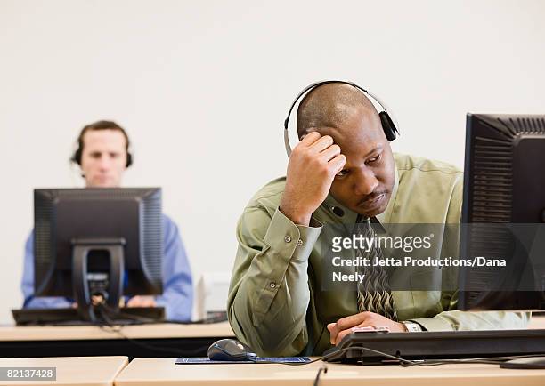 african businessman wearing headset - overdoing stock pictures, royalty-free photos & images