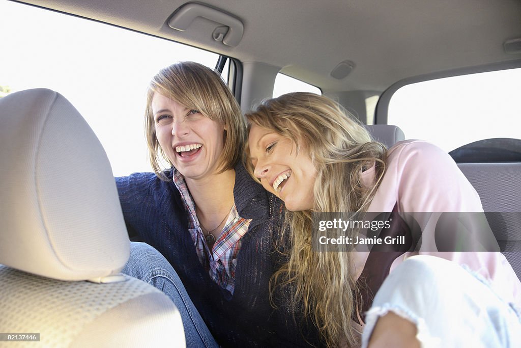 Two women in backseat of car