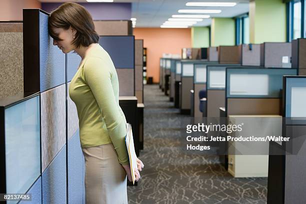 businesswoman leaning head on cubicle wall - overdoing stock pictures, royalty-free photos & images