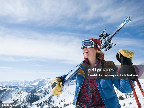 woman holding skis on shoulder - utah skiing stock pictures, royalty-free photos & images