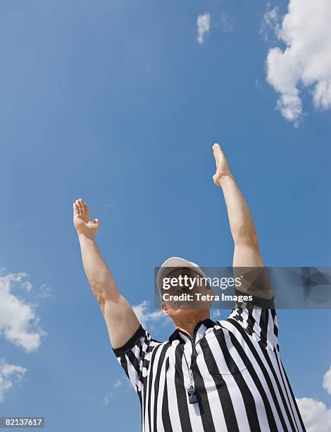 male football referee making touchdown call - football schiedsrichter stock-fotos und bilder