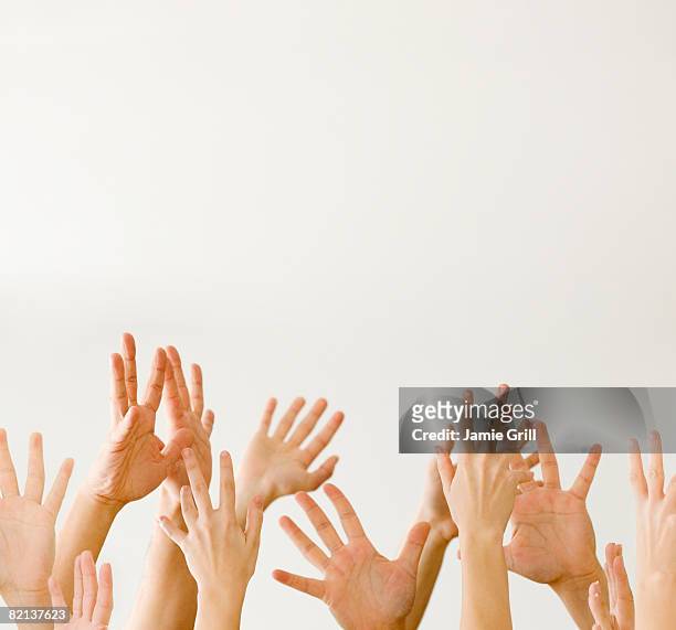assorted hands reaching up - arabische muster stockfoto's en -beelden