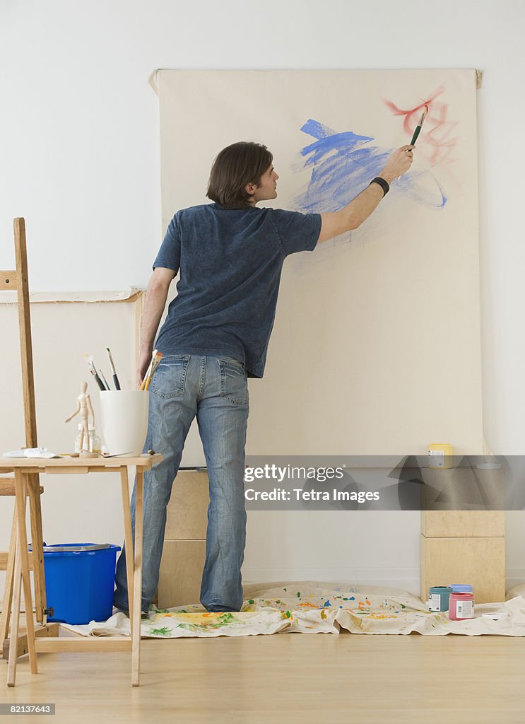 Man painting on easel