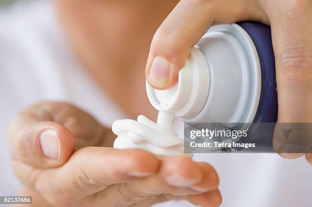 man dispensing shaving cream into hand - raklödder bildbanksfoton och bilder