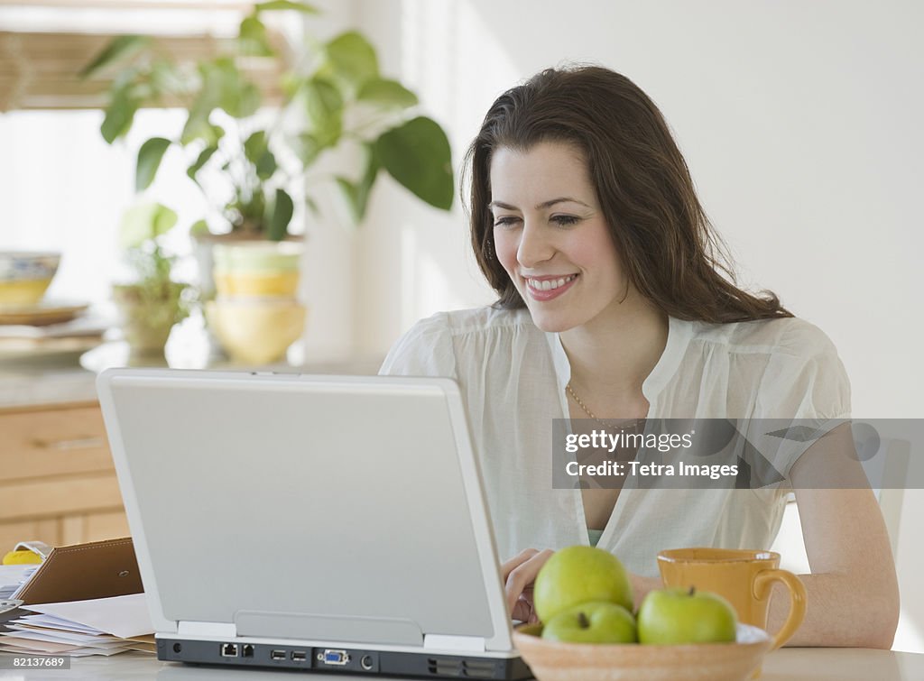 Woman looking at laptop