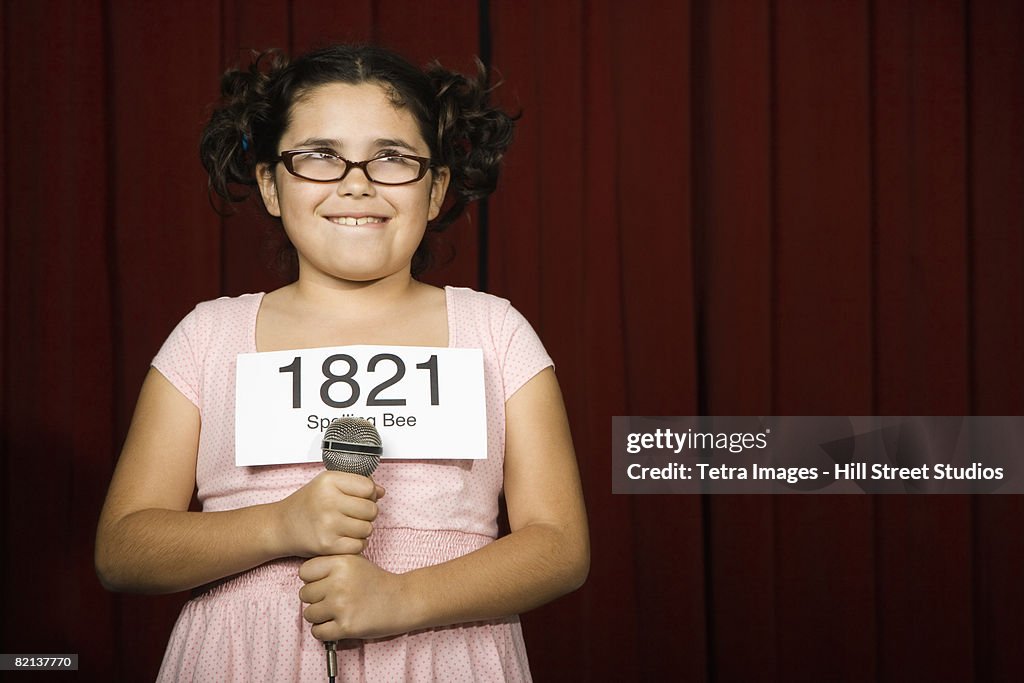 Girl wearing number on stage