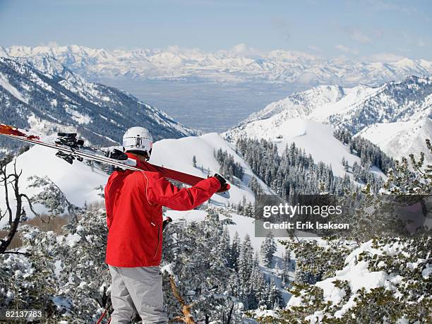 man holding skis on shoulder - wasatch mountains winter stock pictures, royalty-free photos & images