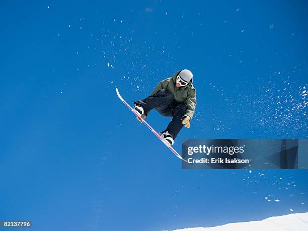 man on snowboard in air - snowboarding stock pictures, royalty-free photos & images