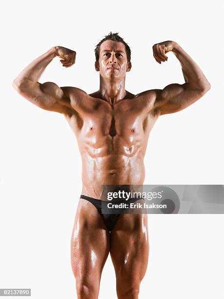 male body builder flexing and posing - bodybuilder flexing biceps stock pictures, royalty-free photos & images