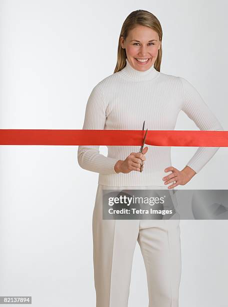 woman cutting red tape - administrative professional stock pictures, royalty-free photos & images