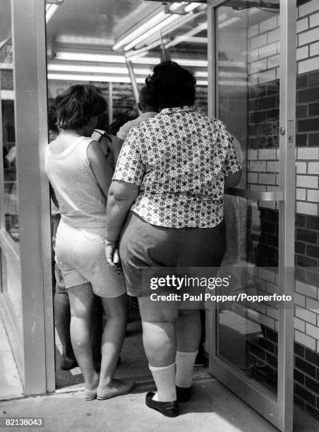 Classic Collection, Page 120 July 1964, New Jersey, USA, A large woman in shorts stands in a queue for food at the Palisades Amusement Park