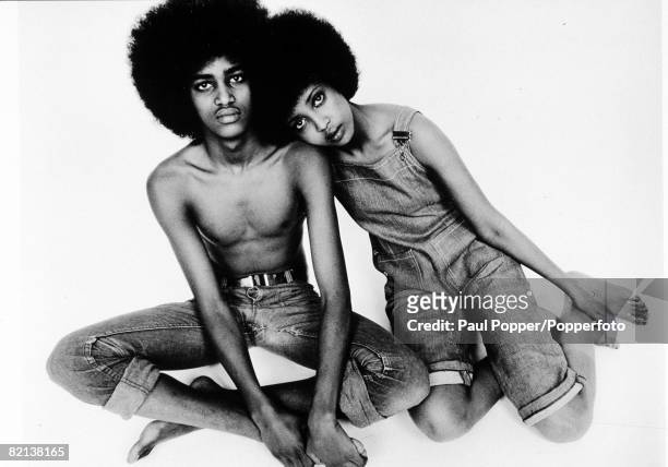 The Book Volume 1, Page 19, Picture 4, "Togetherness", A man and woman each with an "Afro" hairstyle sit together, The man has no shirt on and they...
