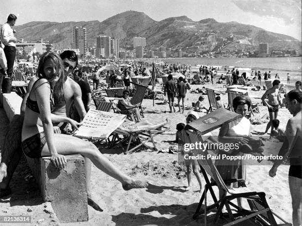 S, Benidorm, Spain, A general view of a continental beach scene, with many people sunbathing