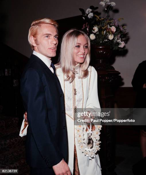 England, 19th August 1967, British actor and singer Adam Faith is pictured with his new wife Jackie Irving after their wedding at Caxton Hall