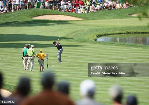 Phil Mickelson of the U.S. Plays his approach shot on the 16th hole during first round of the World Golf Championship Bridgestone Invitational on...