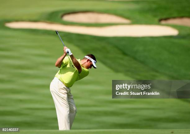 Lee Westwood of England plays his approach shot on the eighth hole during first round of the World Golf Championship Bridgestone Invitational on July...