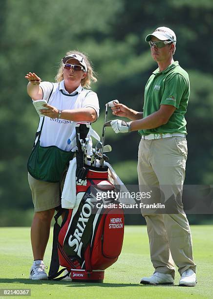 Fanny Suneson gives directions to Henrik Stenson of Sweden on the nineth hole during first round of the World Golf Championship Bridgestone...