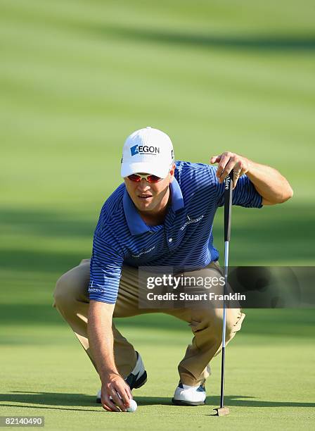 Zach Johnson of the U.S. Lines up his putt on the 18th hole during first round of the World Golf Championship Bridgestone Invitational on July 31,...