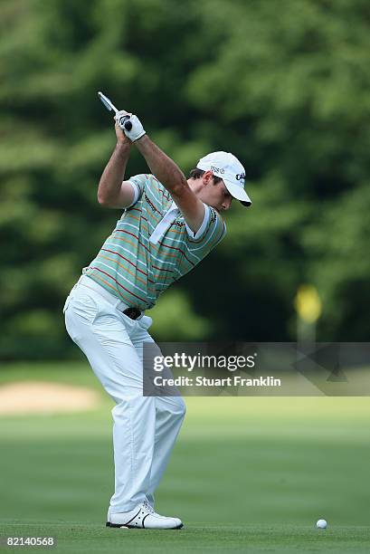 Oliver Wilson of England plays his approach shot on the eighth hole during first round of the World Golf Championship Bridgestone Invitational on...