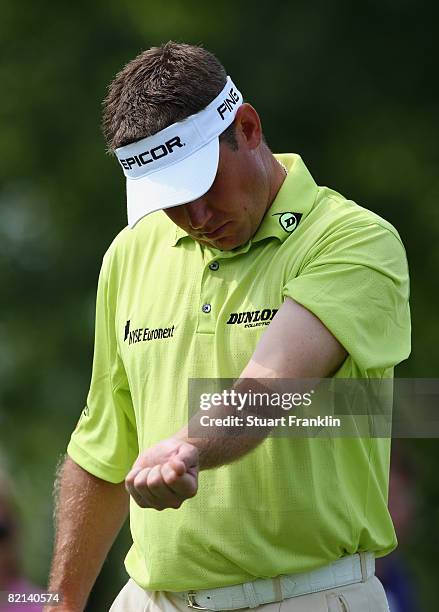 Lee Westwood of England looks at his arm which was stung by a wasp during first round of the World Golf Championship Bridgestone Invitational on July...