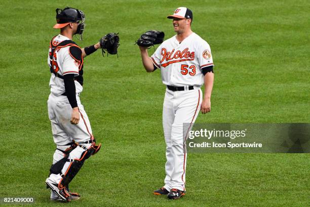 Baltimore Orioles catcher Caleb Joseph congratulates relief pitcher Zach Britton following an MLB game between the Houston Astros and the Baltimore...