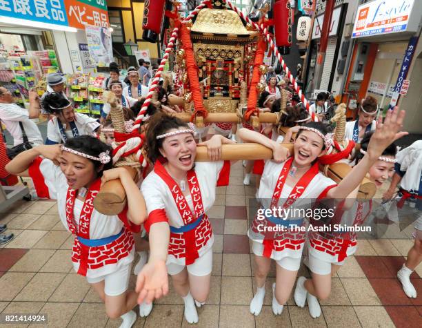 The popular "Gal Mikoshi" is paraded at Tenjinbashisuji shopping street on July 23, 2017 in Osaka, Japan. The troop of 80 women, from 15 to 30 years...