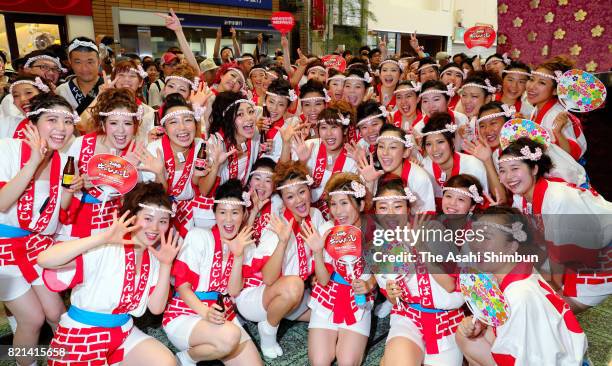 Young women pose for photographs after the popular "Gal Mikoshi" is paraded at Tenjinbashisuji shopping street on July 23, 2017 in Osaka, Japan. The...