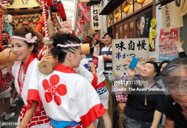 The popular "Gal Mikoshi" is paraded at Tenjinbashisuji shopping street on July 23, 2017 in Osaka, Japan. The troop of 80 women, from 15 to 30 years...