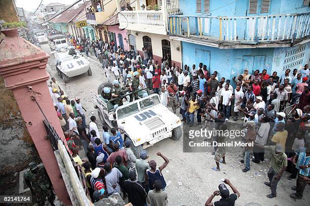Peacekeepers arrive outside a building seized by former soldiers after peacefully ending a standoff July 29, 2008 in Cap-Haitien, Haiti. About 200...