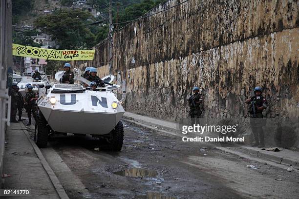 Peacekeepers arrive outside a building seized by former soldiers after peacefully ending a standoff July 29, 2008 in Cap-Haitien, Haiti. About 200...