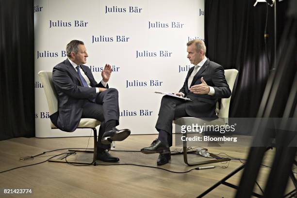 Boris Collardi, chief executive officer of Julius Baer Group Ltd., left, speaks to Manus Cranny, anchor for Bloomberg Television, during a Bloomberg...