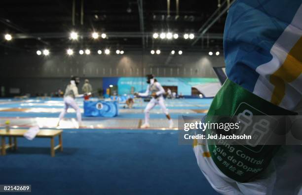 Competitors practice for the fencing under the watchful eye of doping control ahead of the Beijing 2008 Olympic Games on August 1, 2008 in Beijing,...