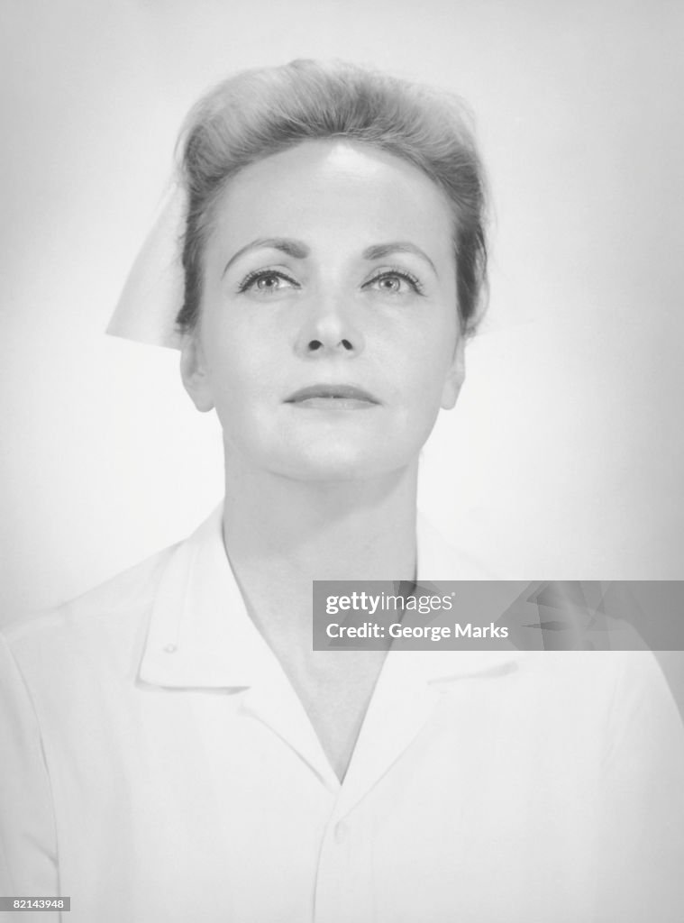 Nurse posing in studio, (B&W), portrait