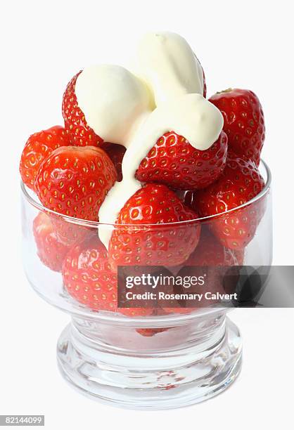 glass dish piled high with strawberries - strawberries and cream stockfoto's en -beelden