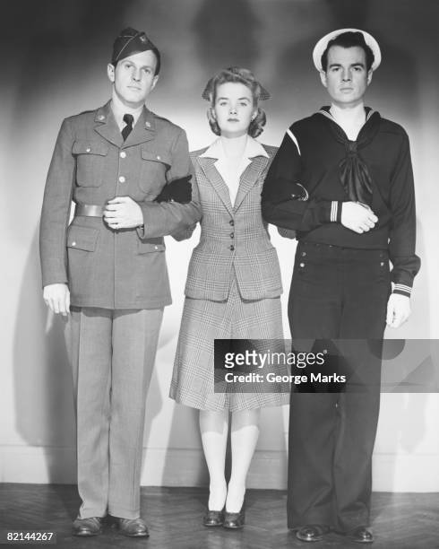 woman posing with man in uniform and sailor in studio, (b&w), portrait - group arm in arm stock pictures, royalty-free photos & images