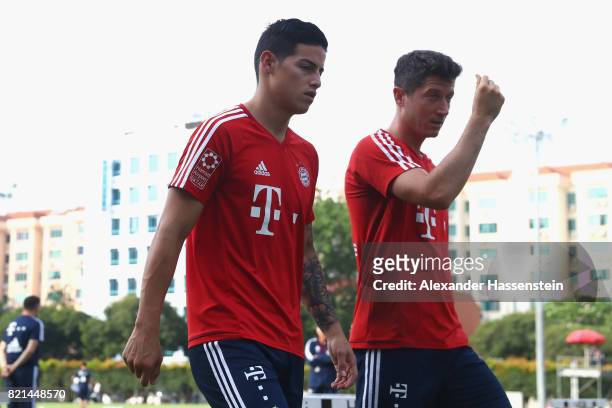 James Rodriguez of Muenchen talks to his team mate Robert Lewandowski during a training session at Geylang Field during the Audi Summer Tour 2017 on...