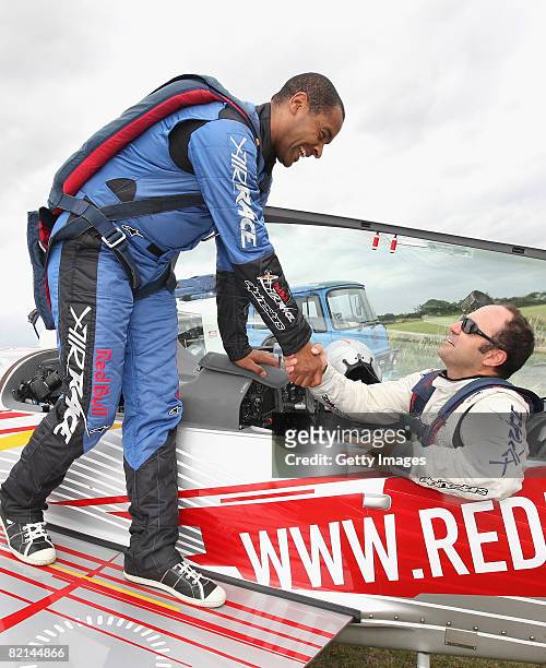 Reporter Mark Bright shakes the hand of Pilot Sergio Bal after returning from his flight during the Redbull Air Race Media Day held at the Damyns...