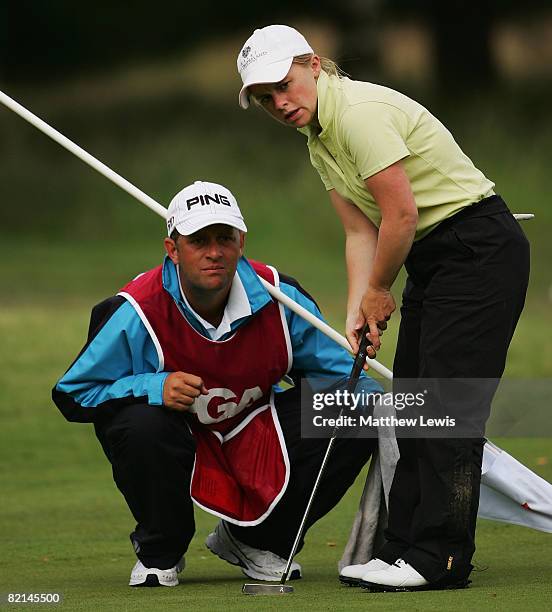 Alexandra Keighley and her caddie line up a putt on the 13th green during the fourth day of the Glenmuir PGA Professional Championships at Moortown...