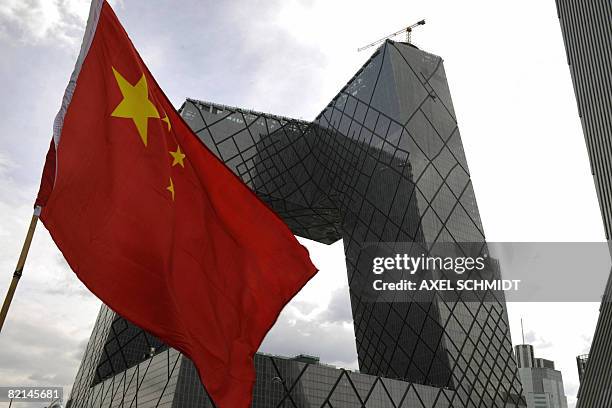 Picture taken on August 1, 2008 in Beijing, where the Summer Olympic Games 2008 will take place, shows a Chinese flag fluttering in front of the...