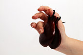 Spanish wooden castanets in a female hand on a white background