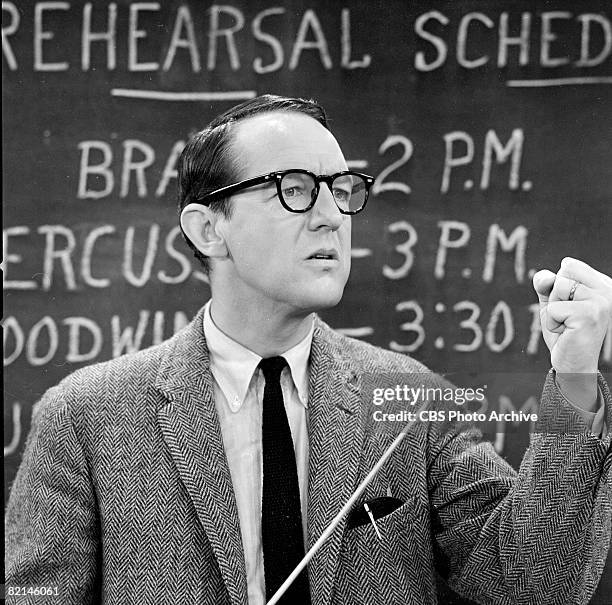 American actor William Schallert, as Mr. Leander Pomfritt, holds a pointer in one hand and makes a fist with the other in a scene from the television...