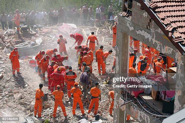 Rescue workers search for the victims in the wreckage of a girls' school dormitory August 1, 2008 in Balcilar, Konya province, Turkey. A three story...
